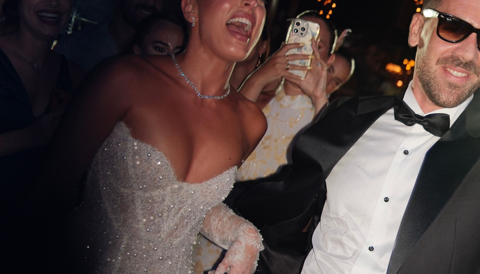 Bride laughing on the dance floor with guests
